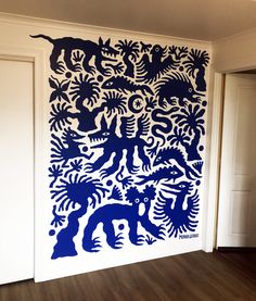 a large blue and white wall hanging on the side of a room next to a door