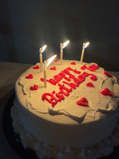 a birthday cake with white frosting and red hearts on it that says happy birthday