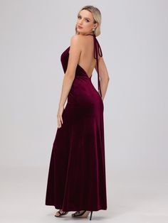 the back of a woman wearing a long velvet dress with one shoulder and open shoulders