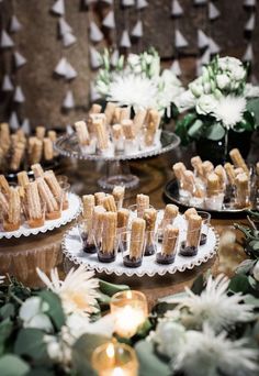 desserts are displayed on small plates with candles