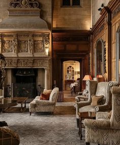 an ornate living room with two couches and chairs