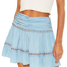 The Esmeralda Skirt From Ramy Brook Is A Flowy Mini Skirt With A Smocked Waist, Lace Insets And Gold Details. Light Blue Flowy Mini Skirt, Elegant Flowy Mini Skirt For Beach, Light Blue Tiered Mini Skirt, Elegant Flowy Mini Skirt For Vacation, Elegant Tiered Mini Skirt For Vacation, Blue Bohemian Mini Skirt With Lined Detail, Blue Bohemian Mini Skirt With Lining, Bohemian Blue Lined Mini Skirt, Light Blue Ruffled Skirt