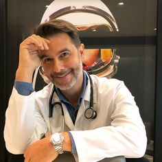 a man with a stethoscope sitting at a desk