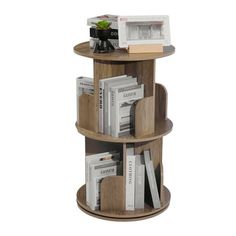 three tiered wooden book shelf with books on top and magazines stacked in the middle