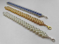 three beaded bracelets on a white surface with gold and silver clasps,