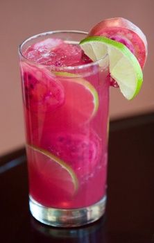 a pink drink with lime and an apple