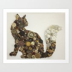 a cat made out of buttons on a white background with the shape of a cat