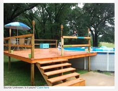 a wooden deck next to a swimming pool with steps leading up to an above ground pool