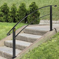 a set of stairs with handrails in the grass