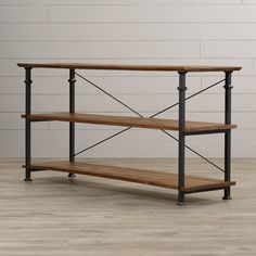 an industrial style wooden and metal shelf with two shelves on each side, against a white brick wall