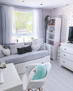 a living room filled with furniture and a flat screen tv