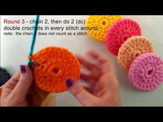 crocheted donuts are being held by someone's hand while they are knitted