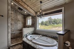 a bathroom with a large jacuzzi tub next to a window