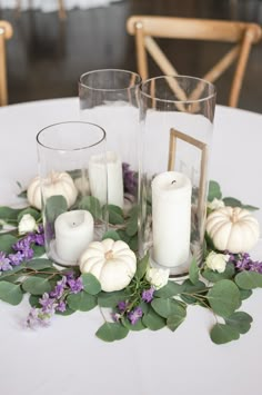 the table is set with white flowers and candles