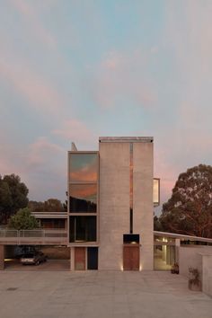 the building is made out of concrete and has multiple windows