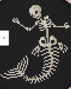 a cross - stitch skeleton is shown in the shape of a round frame with an arrow pointing at it