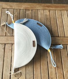 two blue and white hats sitting on top of a wooden floor