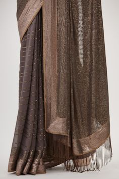 Charcoal wave patterned saree with sequin work and fringe pallu. Paired with embroidered sleeveless blouse.
Components: 2
Pattern: Embroidered
Type Of Work: Sequin
Neckline: Scoop
Sleeve Type: Sleeveless
Fabric: Chiffon
Color: Grey
Other Details: 
Sequin work
Embroidered blouse
Occasion: Sangeet,Reception - Aza Fashions Bollywood Party Pre-draped Saree With Tassels, Elegant Pre-draped Party Saree With Tassels, Elegant Wedding Saree With Tassels, Bollywood Style Pre-draped Saree With Tassels For Party, Elegant Saree With Tassels For Reception, Elegant Tasseled Dupatta For Party, Festive Wedding Blouse Piece With Tassels, Bollywood Blouse Piece With Tassels In Traditional Drape, Bollywood Blouse Piece With Traditional Drape And Tassels