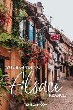 an alley with flowers growing on it and the words your guide to alsacce france