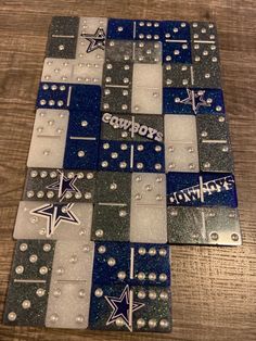 the nfl team's logo is made out of metal and glass tiles on a wooden table