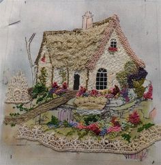 a house with flowers on the outside and a fence around it