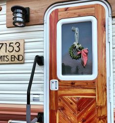 the front door of a mobile home with a wreath on it