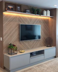 an instagram photo of a living room with a tv on the wall and shelves