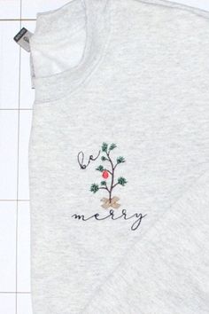 "This super comfy crewneck sweatshirt is perfect for the holiday season! On the left chest, a tree is embroidered with the words \"be merry\" in black thread around the tree. These adult unisex sweatshirts are 50% cotton, 50% polyester. Please see size chart to determine the best size. This listing is for 1 sweatshirt. Are you looking for an item that is not listed? Please send me a message and let's see if we can create your item! Thank you for browsing my shop! Find us on Facebook! All items a Stick Christmas Tree, Embroidered Crewneck, Black Thread, Unisex Sweatshirt, White Undershirt, Size Chart, Crew Neck Sweatshirt, Merry Christmas, I Shop