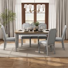 a dining room table and chairs in front of a window