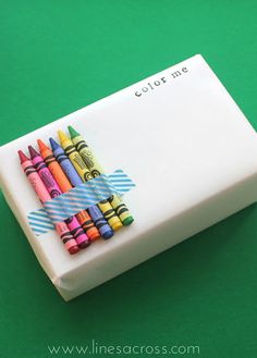 there are crayons on top of the eraser and it says color me