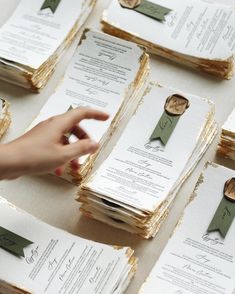 a table topped with lots of cards and envelopes covered in waxed paper on top of each other