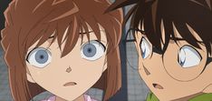 two anime characters looking at each other with blue eyes and brown hair, one is frowning