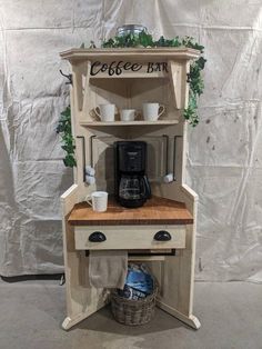 a coffee bar made out of an old cabinet