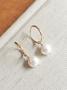 These dainty freshwater pearl hoops are the perfect accessory to complete that minimalist modern look! Great to give as a gift or to treat yourself! --------------------------- D E T A I L S * Earrings are made out of 14k gold-fill wire - Great for those sensitive to specific metals - Lightweight for easy wear * Hand-shaped rounded wire (14mm in diameter - 1.20mm thick) * Pearls measure 8mm * Ethical sourcing of all materials * Packaged neatly + securely in a reusable drawstring bag - ready to g Minimalist Teardrop Hoop Earrings With Pearl Charm, Minimalist Pearl Charm Hoop Earrings For Everyday, Minimalist Pearl Hoop Earrings Hypoallergenic, Minimalist Hoop Earrings With Pearl Drop, Minimalist Small Hoop Pearl Drop Earrings, Minimalist Everyday Hoop Earrings With Pearl Charm, Minimalist Pearl Drop Hoop Earrings, Minimalist 14k Gold-filled Hoop Earrings With Pearl Charm, Delicate Hoop Earrings With Pearl Charm For Everyday