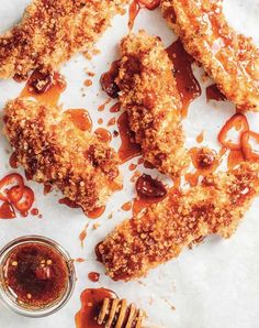 some food is laying out on a table with sauce and honey in front of it