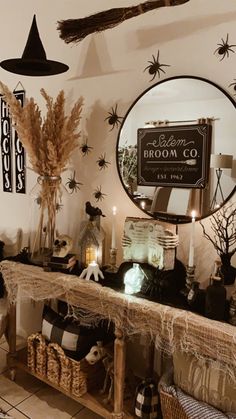 a room decorated for halloween with spider webs and brooms on the wall above