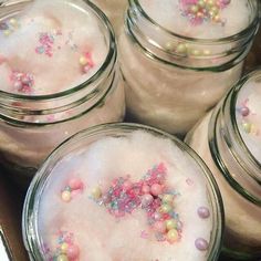 several jars filled with different types of confetti