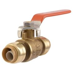 a brass ball valve with an orange handle