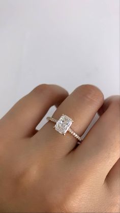 a woman's hand with a diamond ring on it