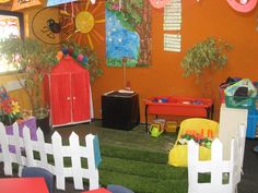 an indoor play area with chairs, tables and umbrellas for children's birthday party