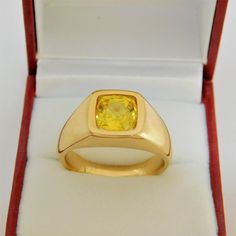 Gemstone: Yellow sapphire A gem certificate of authenticity will be provided at no charge. Treatments: Heated/Lattice Diffusion Specifications: 8.03x8.1mm, approx. 2.89 carats Color: As shown Stunning rare lemon yellow Clarity: Eye clean, almost loupe clean Cut: Cushion cut Weight: 16 grams. Ring size: 10, with all sizes available from 6.5 through 12 This is as fine and elegant a man's ring as you will ever find. The perfect blend of a fine gemstone matched up with a clean classic 14K yellow gol Classic Yellow Gold Ring With Yellow Sapphire, Classic Yellow Gold Yellow Sapphire Ring, Classic Yellow Sapphire Yellow Gold Ring, Gia Certified Oval Gold Sapphire Ring, Gold Cushion Cut Topaz Ring For Formal Occasions, Formal Gold Cushion Cut Topaz Ring, Classic Yellow Sapphire Ring For Formal Occasions, Modern Gia Certified Sapphire Ring As Gift, Gold Sapphire Ring With Cushion Cut