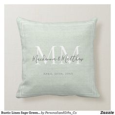 a personalized pillow with the initials and date on it, in light green linen