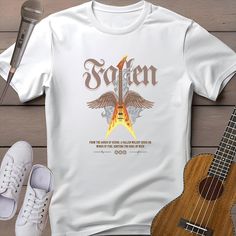 Ignite your love for music with this bold guitar t-shirt! Perfect for any music lover or guitarist, this tee features a fiery electric guitar, embodying the spirit of vintage rock n roll. Whether you're heading to a music festival or just showing off your love for classic tunes, this retro guitar shirt is sure to turn heads. Ideal for musicians, guitar lovers, and anyone who appreciates an old school band tee, it's the ultimate guitarist gift shirt. Rock on and let the world know: Let's rock! 🎸  Gildan 64000 Softstyle Tee 🎸  100% Ring-spun Cotton 🎸  Unisex Fit Tee 🎸  Light Fabric 🎸  Runs True to Size CARE INSTRUCTIONS: - Wash cold, inside out - Tumble dry low or hang dry - Do not iron directly on the design - Avoid bleach SHIPPING INFO: USA and EUROPE: Orders are typically processed w Cheap Music-themed Fan Merchandise Shirt, Guitarist Boyfriend, Retro Guitar, Guitar Lover, Guitarist Gifts, Guitar Shirt, Guitar Lovers, School Band, Rock N’roll