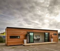 a small wooden building sitting on top of a parking lot