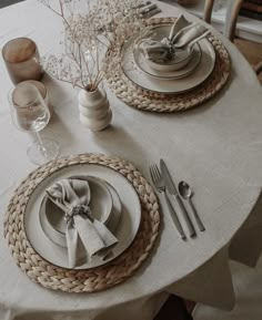 the table is set with plates and silverware