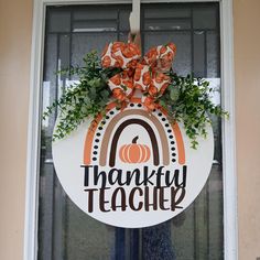 a door hanger that says, thank teacher with an orange and white pumpkin on it