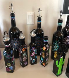 the bottles are decorated with different designs and colors, but not all have holes in them