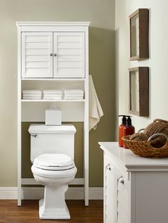 a white toilet sitting in a bathroom next to a bath tub