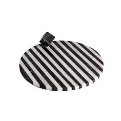 a black and white striped coaster with a bow on the top, sitting in front of a white background