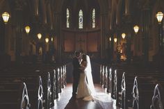 a bride and groom standing in front of the alter at their wedding ceremony with lights on